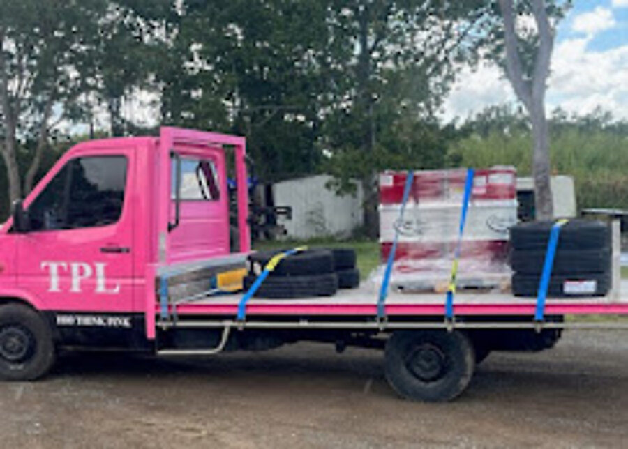 Think Pink Logistics truck loaded with secured freight bound for a rural property